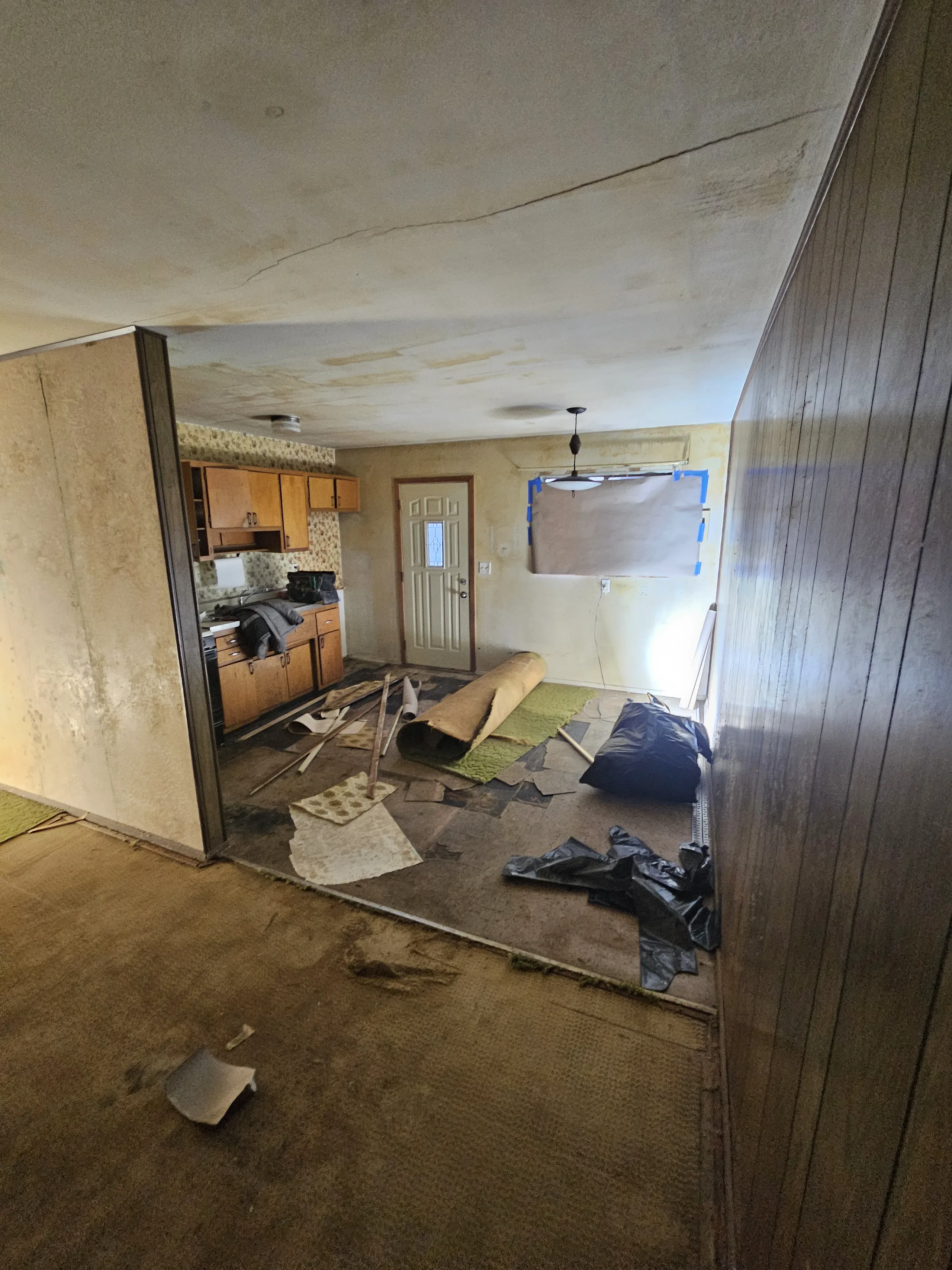 A cluttered room showing demolition services in progress with exposed walls and debris