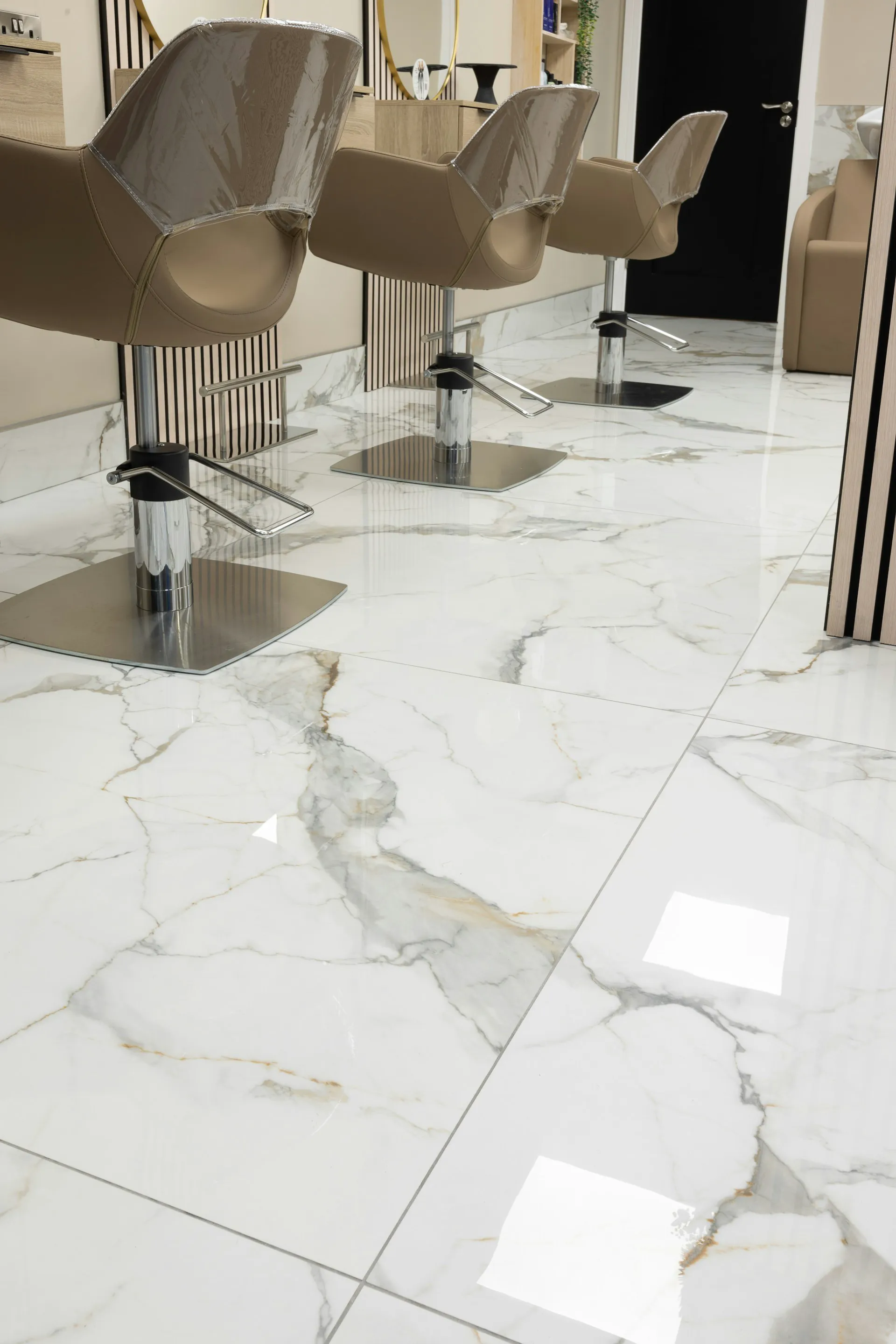 Elegant marble tile flooring in a salon with stylish hairdressing chairs